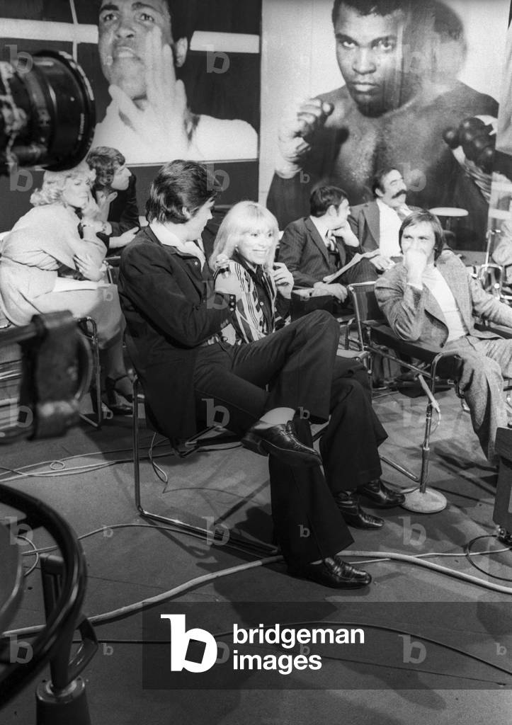 Alain Delon and Mireille Darc on tv set for boxing championship, 1974 (b/w photo)