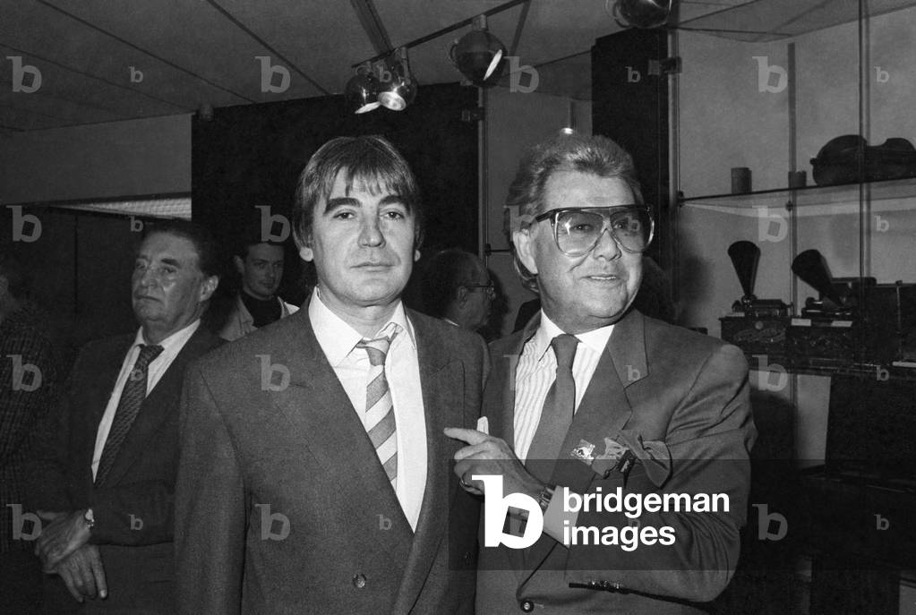 French Singer Serge Lama congratulated by Michou (Michel Georges Alfred Catty) for his Legion of Honour, 2 March 1989 (photo)