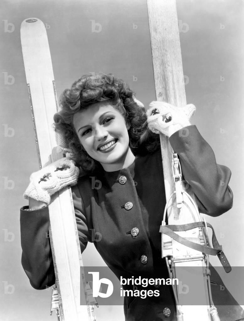 Rita Hayworth ready for winter, poses with her skiis, c. 1951 (photo)