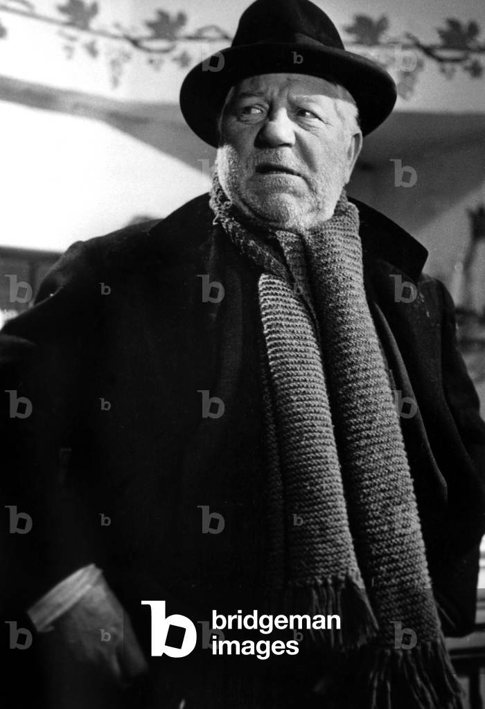 Jean Gabin dressed as a tramp on the set of the film 