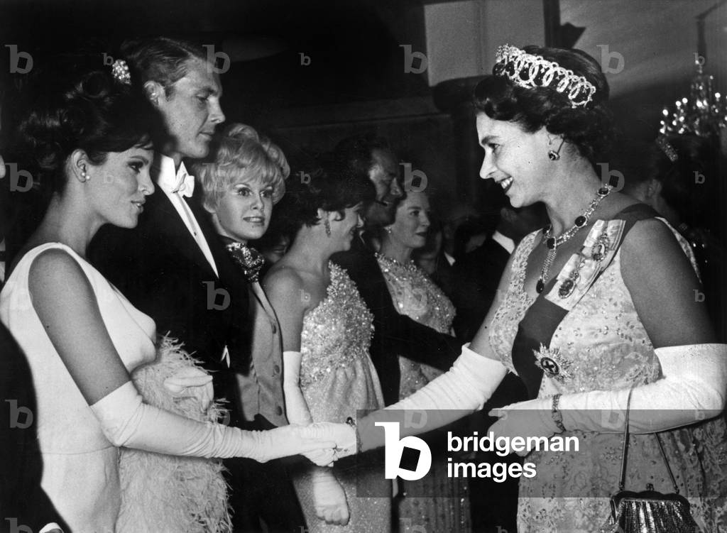 Queen Elizabeth II of England and Raquel Welch, 1966 (b/w photo)