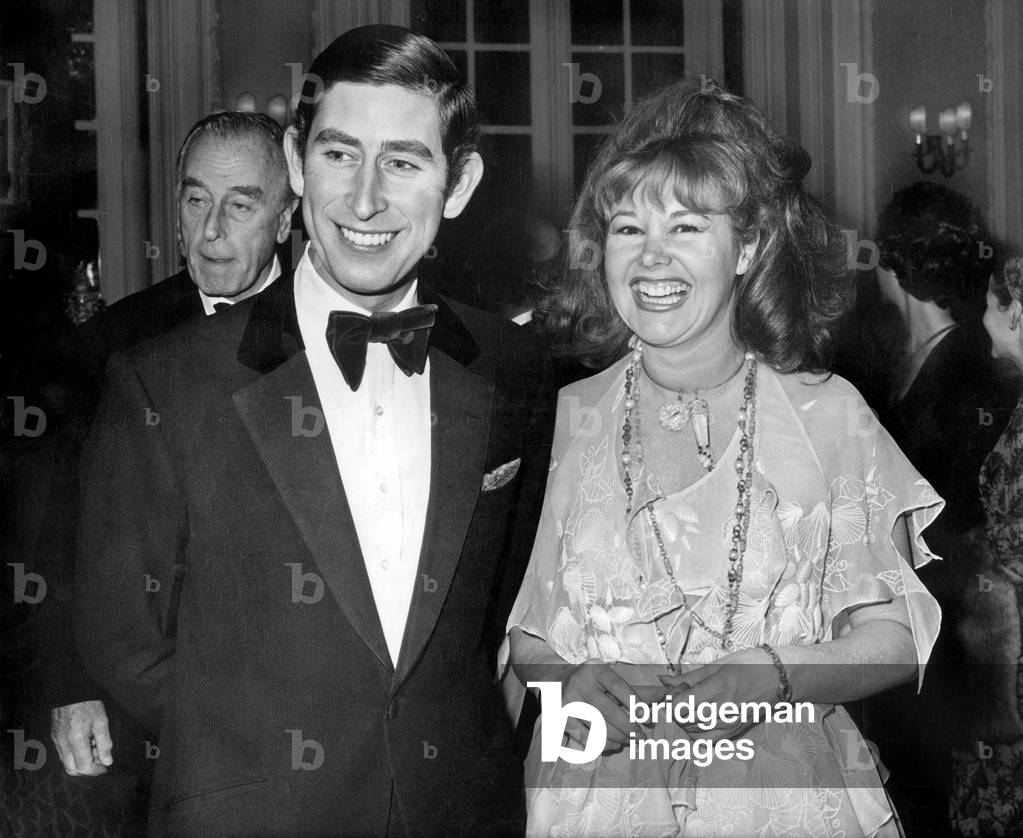 Prince Charles (Future Charles III) and Mrs Harmsworth at a charity auction sale, London, November 21, 1973 (b/w photo)