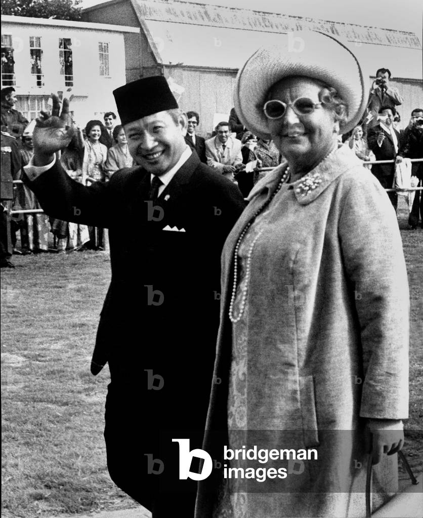 President Suharto of Indonesia on an afficial one day visit to Holland here at the airport with Queen Juliana of Holland before going to the palace in The Hague September 9, 1970 (b/w photo)