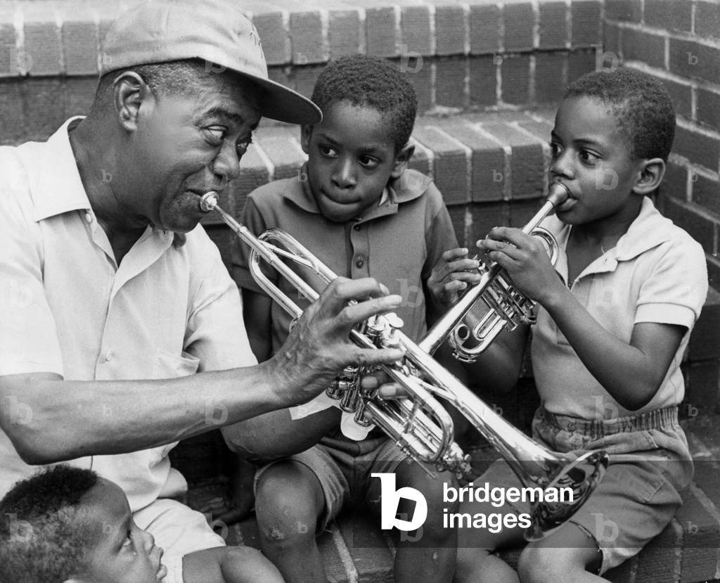 Louis Armstrong with children, New York, USA, 1970 (b/w photo)