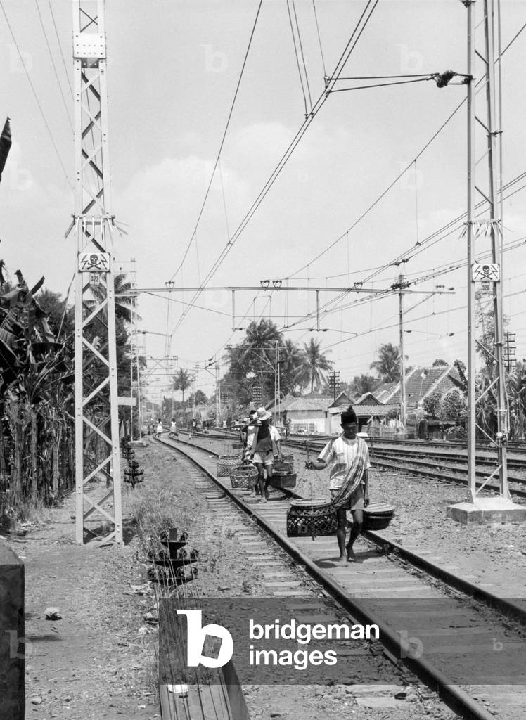 In Djakarta in Indonesia, Railway Road With Porters, December 1961 (b/w photo)
