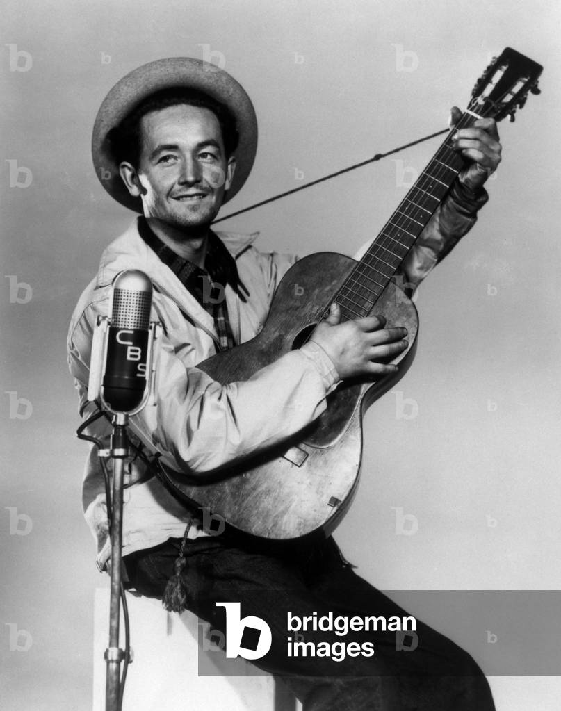 Musician Woody Guthrie (1912-1967) Considered As The Father of Folk Music C. 1942 (b/w photo)