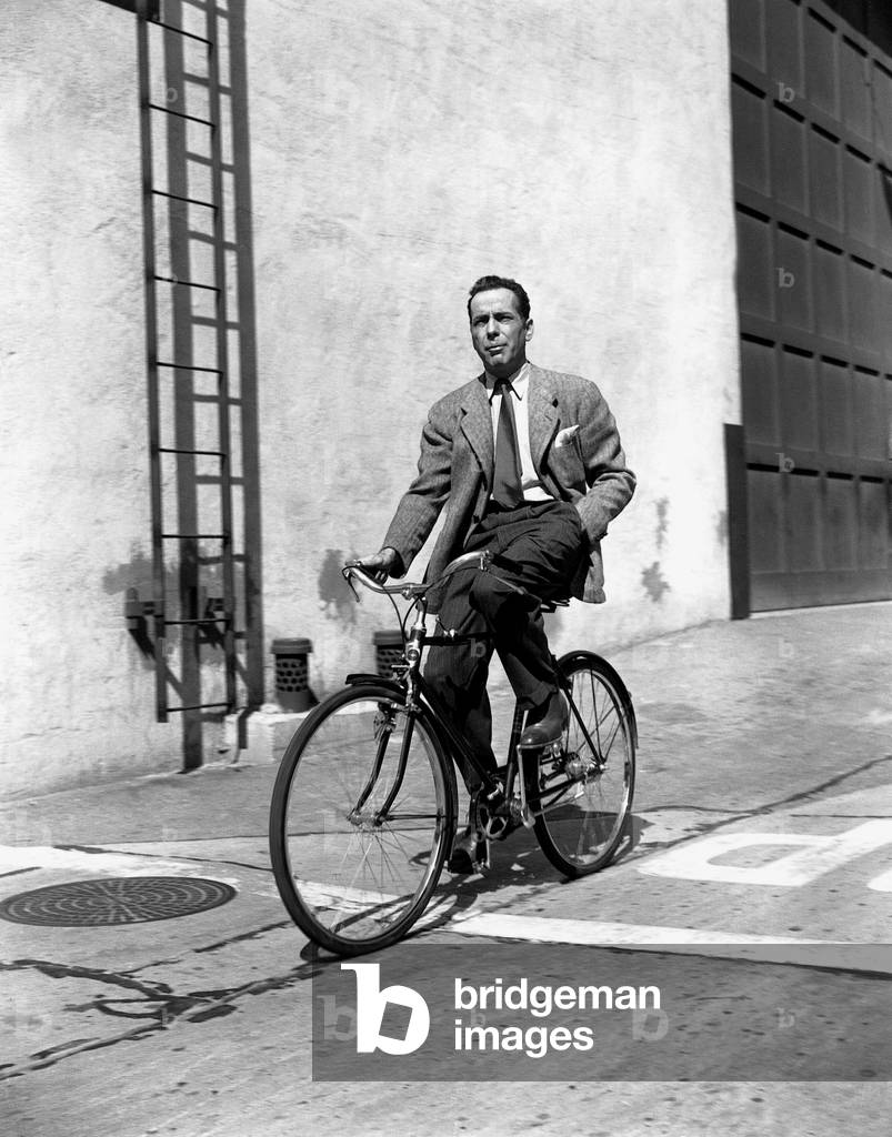 American Actor Humphrey Bogart on A Bicycle, C. 1945 (b/w photo)