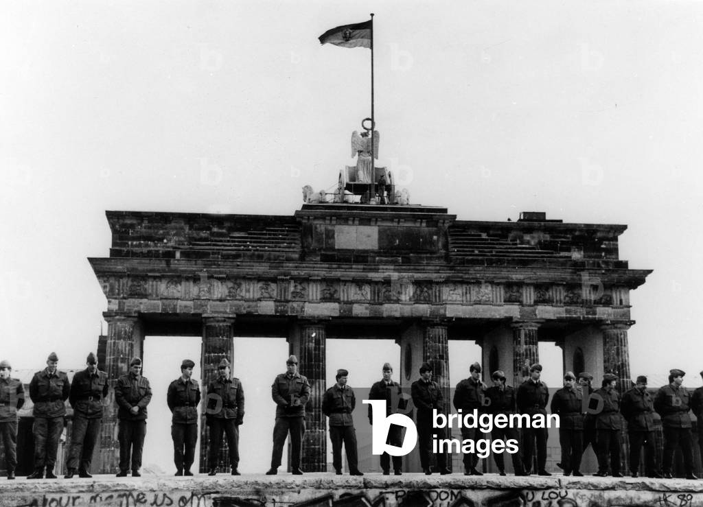 East German soldiers on the wall in front of the Brandenburg Gate, november 12, 1989 (b/w photo)