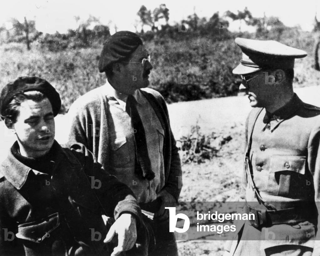 Ernest Hemingway (1899-1961) with Gustav Regler and Joris Ivens in uniform during Spanish civil war filming of Terre d' Espane 1937