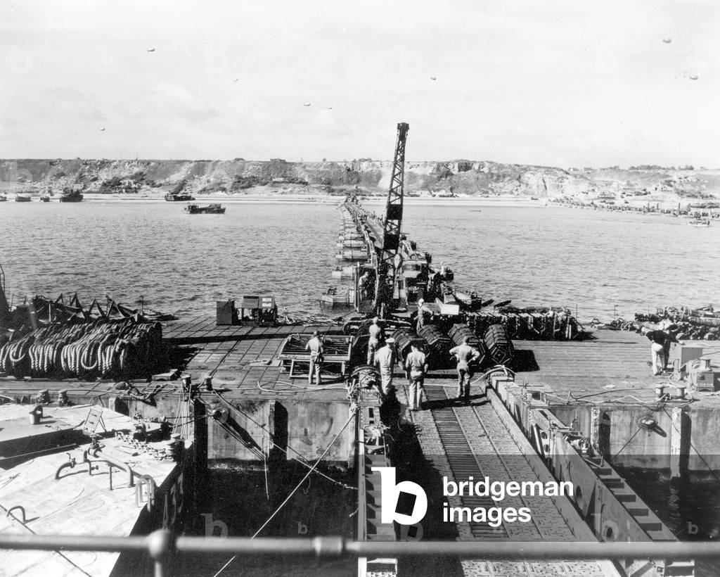 Mulberry A (American) and Mulberry B (British) bridges set from a boat towards Omaha Beach (Colleville sur Mer) at least one week after the Normandy landings in France to unload equipment, mid- June 1944