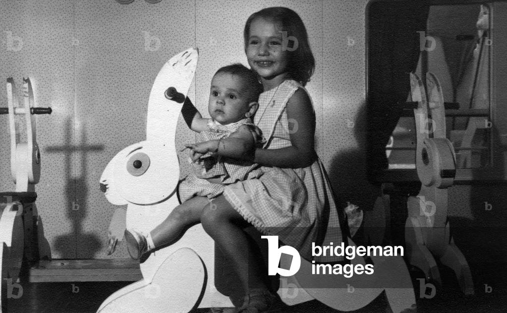 Young girl and her little brother on a manege rabbit on the liner Jean Mermoz 1962 (link Nigeria-Marseille)