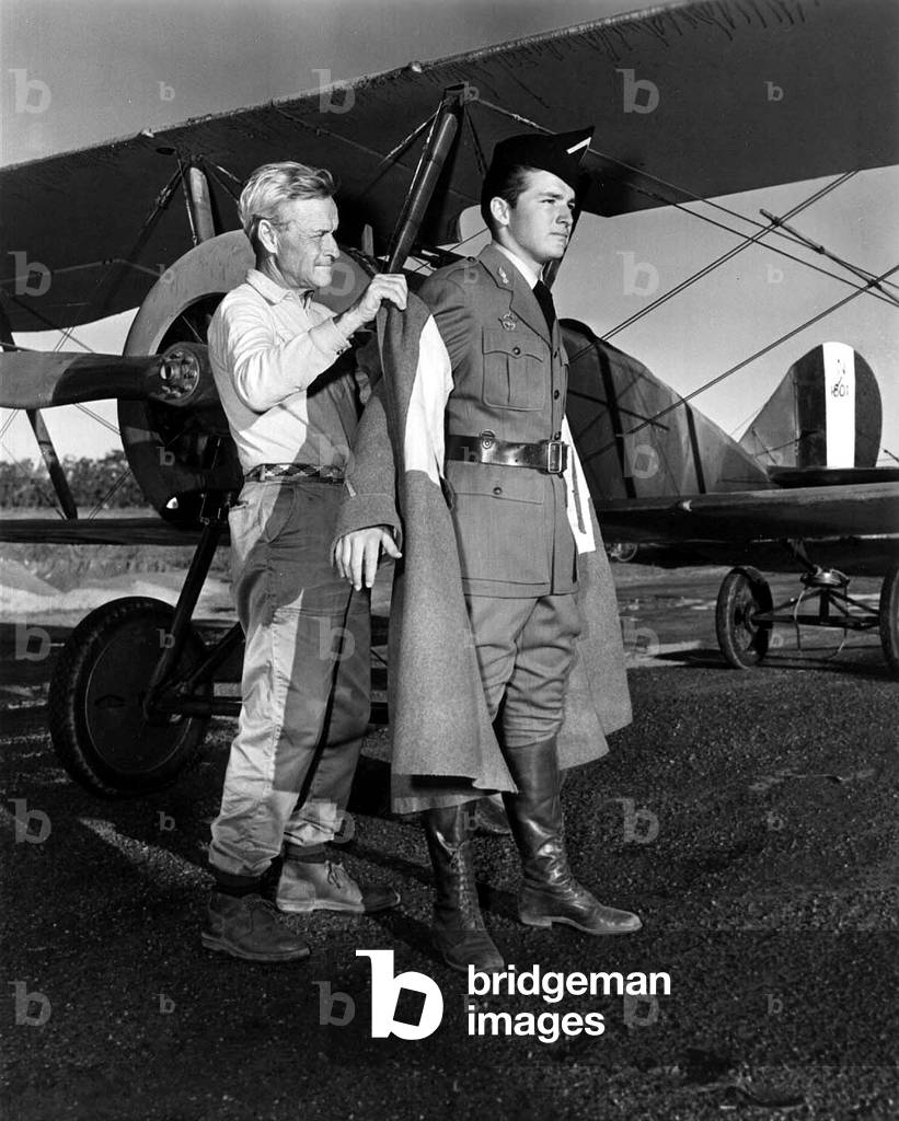 William A. Wellman (1896-1975) American director with his son William Wellman Jr he help to slip on his coat of pilot c. 1957