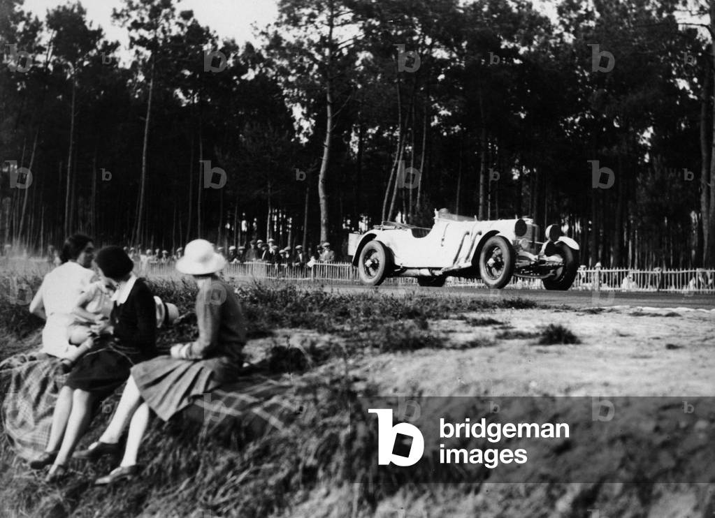 Mercedes-Benz SS in action at the Le Mans 24 Hours, France, 1930. Women spectators watch the car of Rudolf Caracciola and Christian Werner speed past. The car retired with a flat battery after completing 85 laps