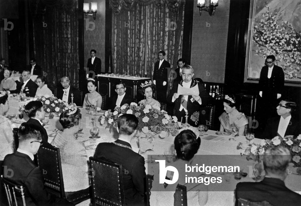 Belgian King  Baudouin and Queen Fabiola of Belgium during a diner at imperial palace in Tokyo on January 21, 1964 : r-l : Prince Mikasa, Princess Michiko, japanese emperor Hiro-Hito, Queen Fabiola, prince Yosia, Princess Mikasa ; back : Hayato Ikeda, Princess Chichibu, King  Baudoin, prince Akihido and Princess Takamatsu