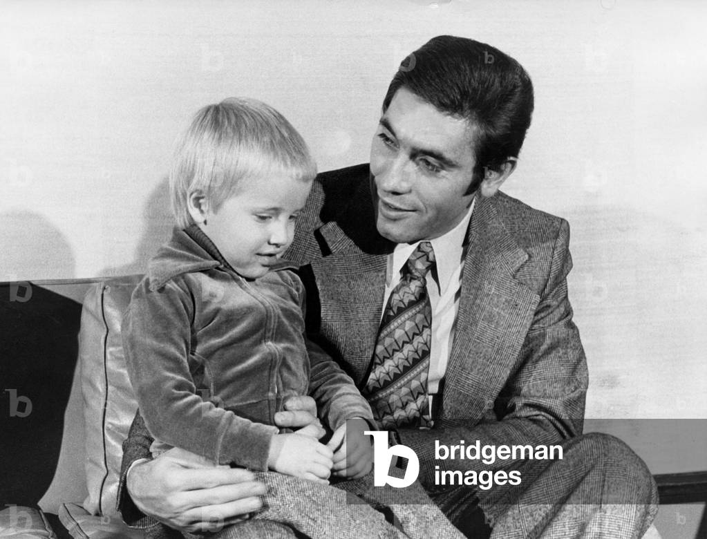 Belgian cyclist Eddy Merckx receiving cycling prize, here in Brussels with his son, 1975