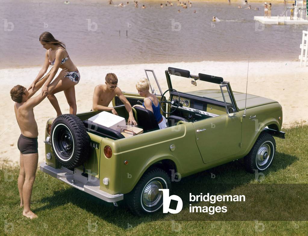 Advertising photograph of two young couples in swimsuits getting out of an International Scout pickup truck near a public beach, 1969