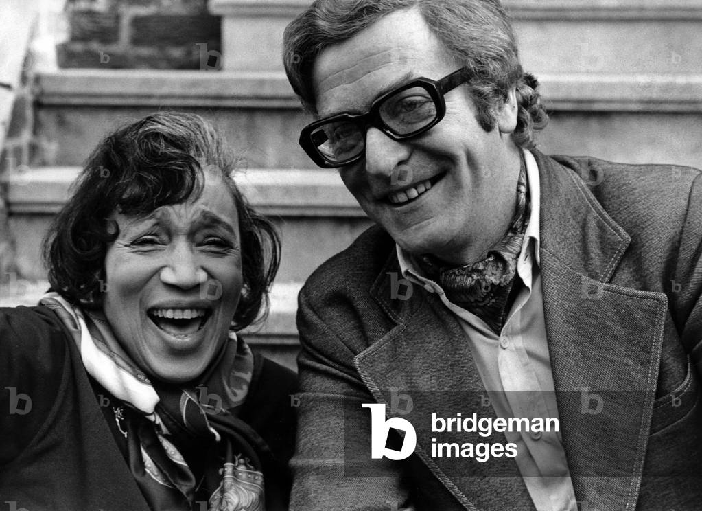 Actor Michael Caine with singer and actress Elizabeth Welch, to promote ticket sales for a charity show with the help of the Stars for Spastics Organization, September 19, 1973. Neg: A79899PL