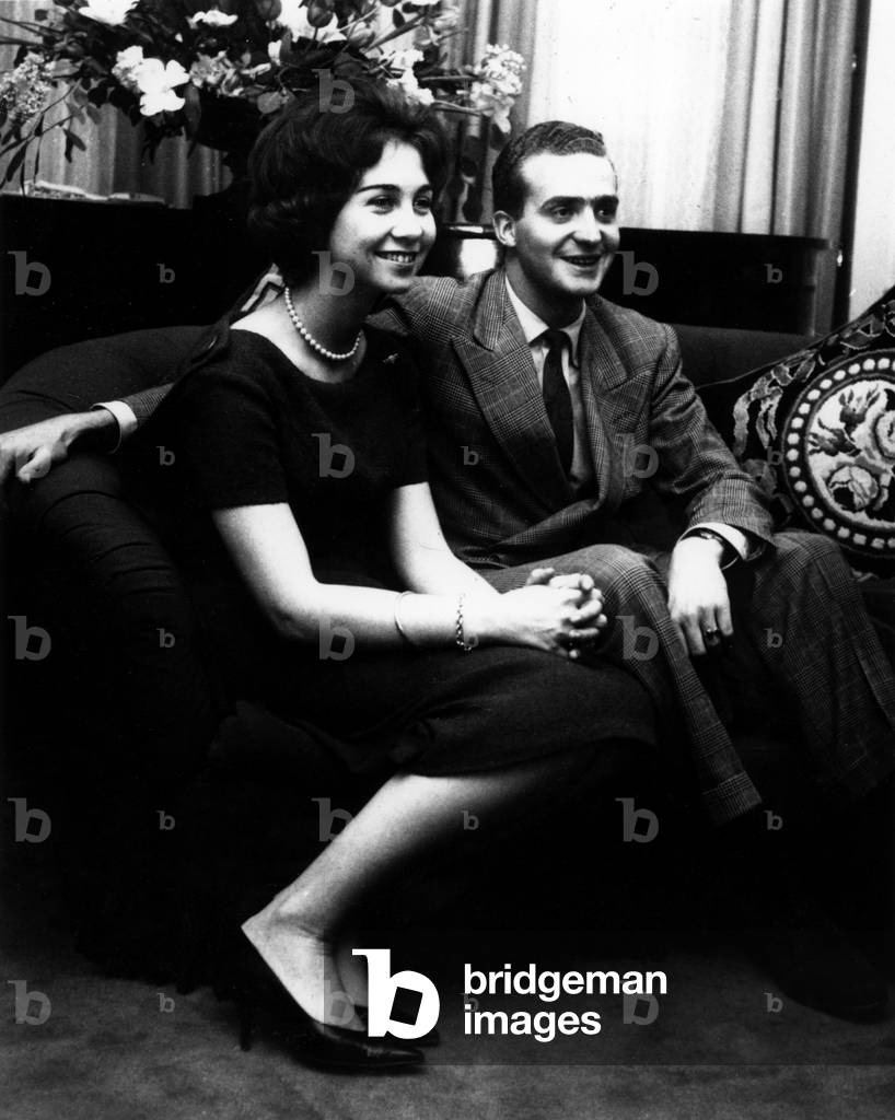 The Spanish prince Juan Carlos of Borboun wearing a tuxedo as he is sitting next to fiancee Sophia of Greece. 1961