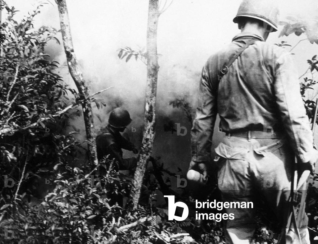 Pacific Front during Okinawa battle, April-June 1945 : 96th Division US Marines toss white phosphorous fragmentation grenades to flush the Japanese snipers out of jungle
