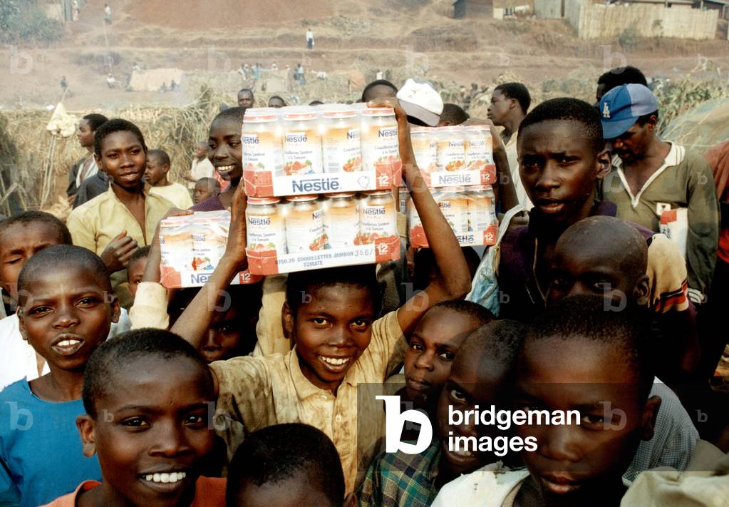 Children receiving food in the refugee camp in Bukavu, Zaire August 09, 1994