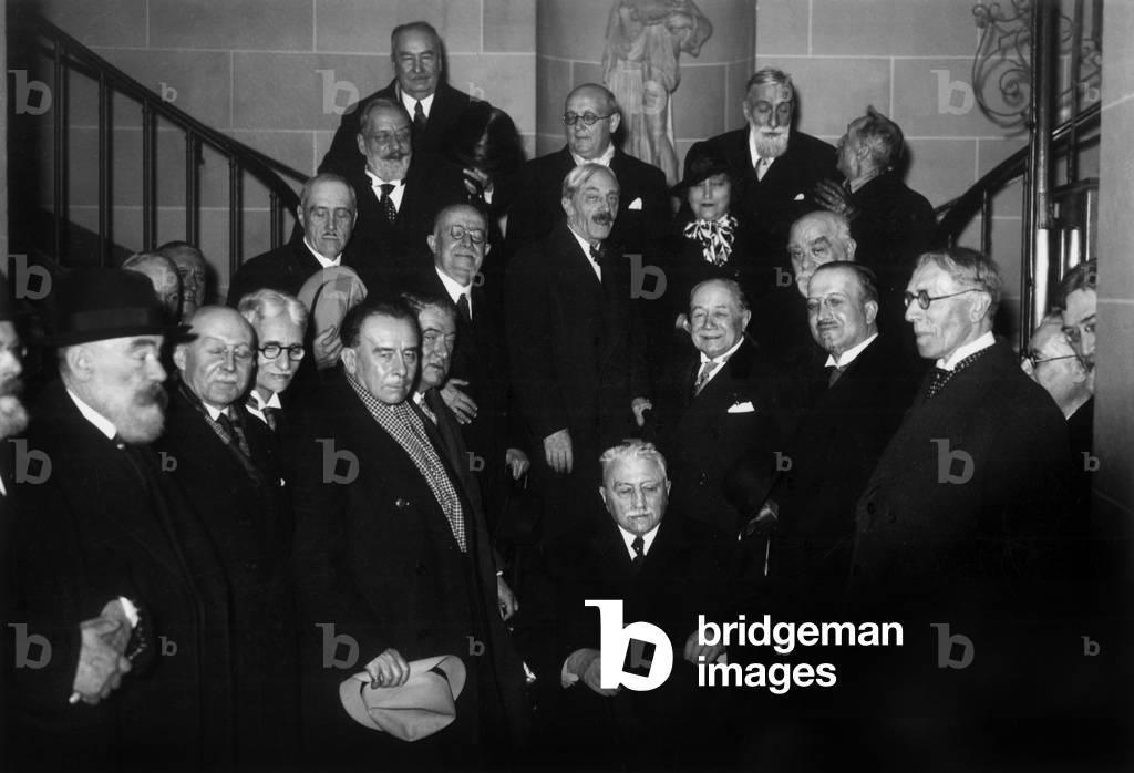 Members of Belgian academy of French literature, 1937   on l : Georges Marlow, Louis Dumont Wilden, Charles Bernard, Alphonse Bayot in c : Emile Boisacq (seated front), Maurice de Maeterlinck (standing in c) and Colette on r : Henri Simon, Gustave Charlier, Georges Virres
