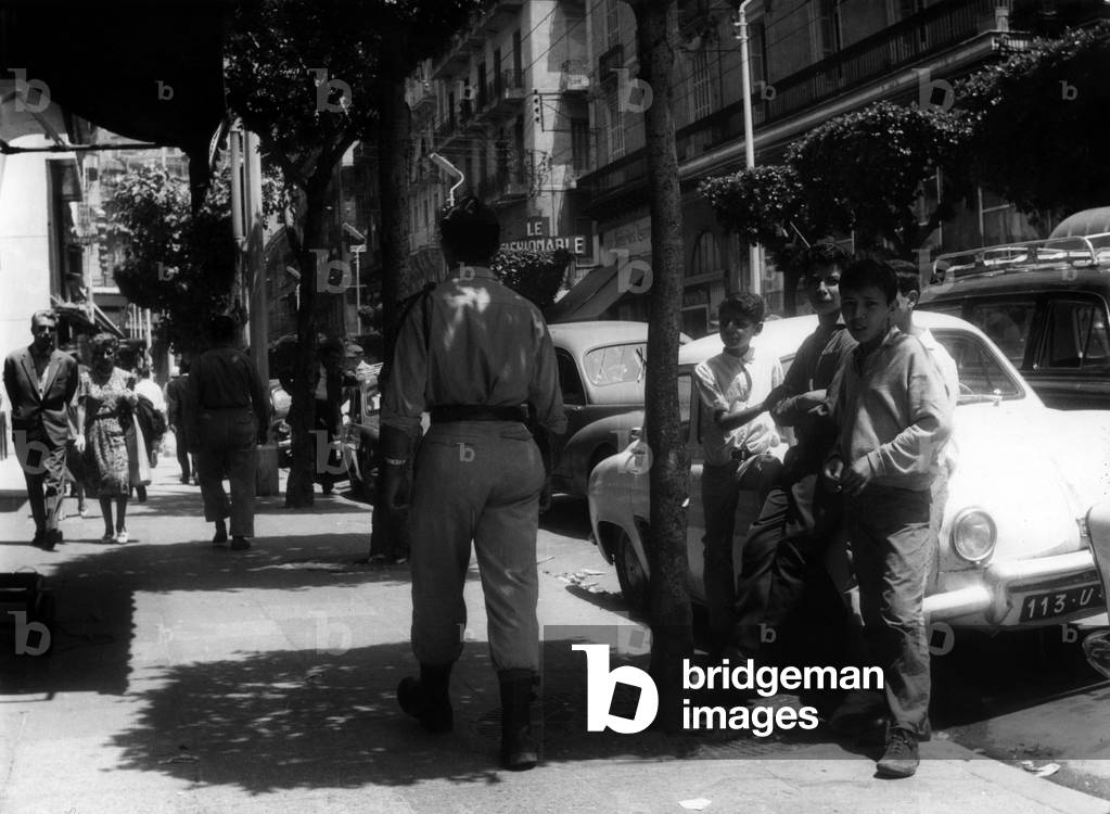 Algiers after war : young muslims, soldier and couple in a street, June 22, 1962