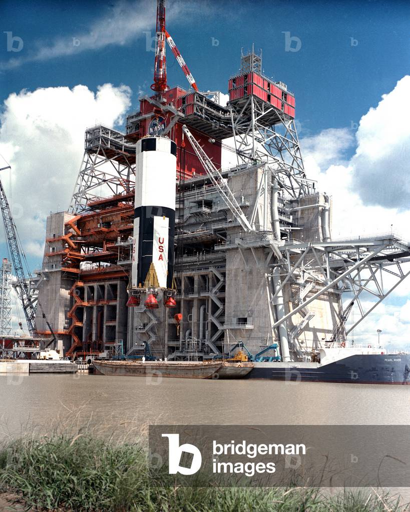1967 : The first stage of the huge Apollo Saturn V moon rocket is lifted by crane for installation into the B-2 test stand at the Mississippi Test Facility