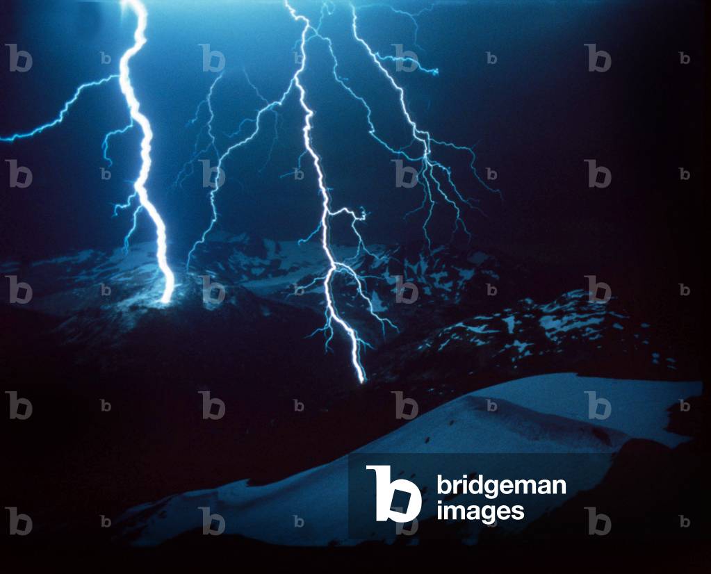 Lightning during a storm over snowy mountains