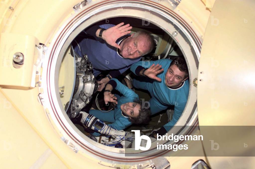 (23-31 October 2001) The Soyuz Taxi crewmembers wave from a Soyuz spacecraft docked to the International Space Station (ISS). Clockwise from the top are Commander Victor Afanasyev, Flight Engineer Konstantin Kozeev and French Flight Engineer Claudie Haignere