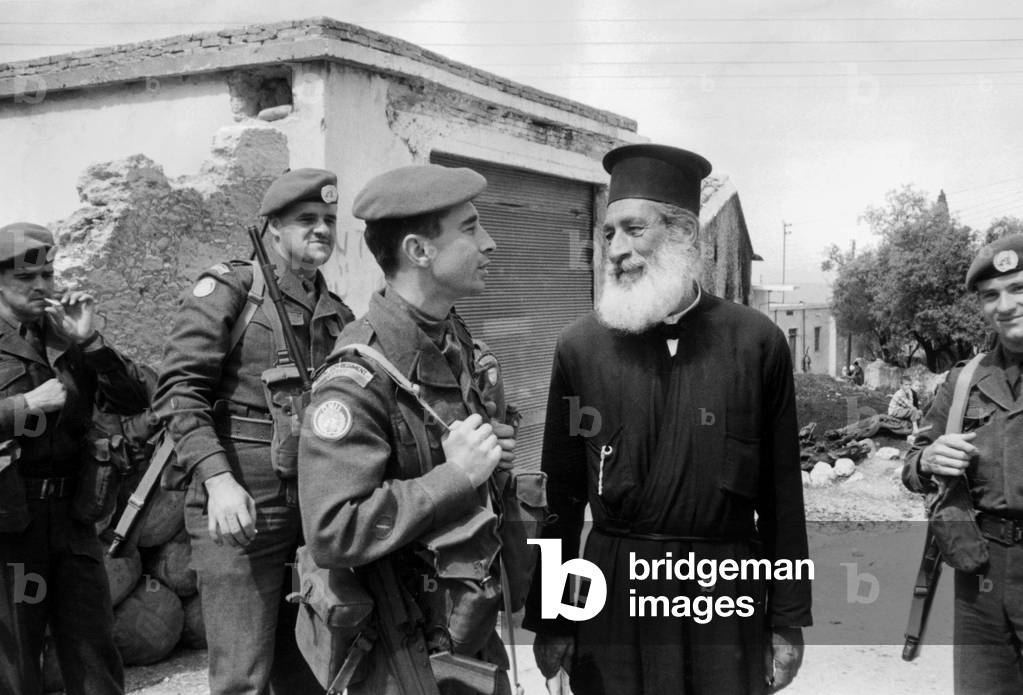 Canadian Blue Helmet of UNO troops took position in Cyprus here in Kazaphani village talking with greek orthodox priest March 31, 1964