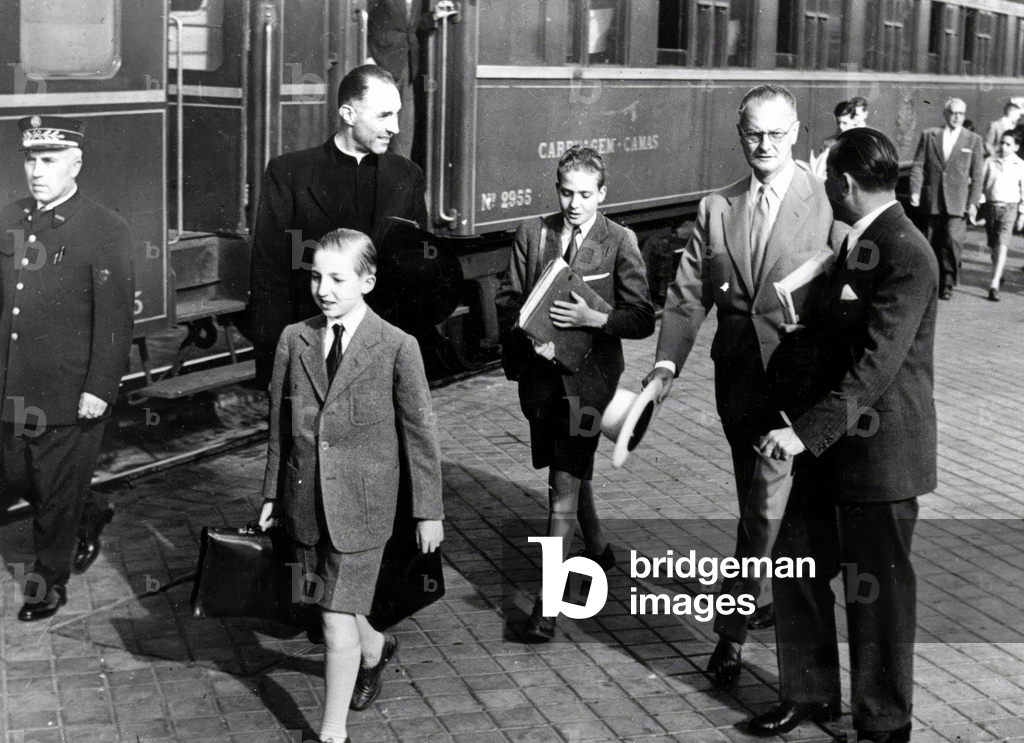 Prince Juan Carlos (future King  Juan Carlos 1st) with his brother Alfonso and his uncle at station c. 1953