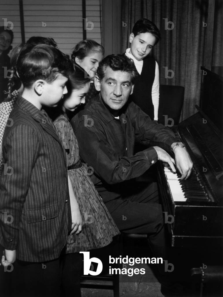 American composer Leonard Bernstein (1918-1990) during a music lesson c. 1958