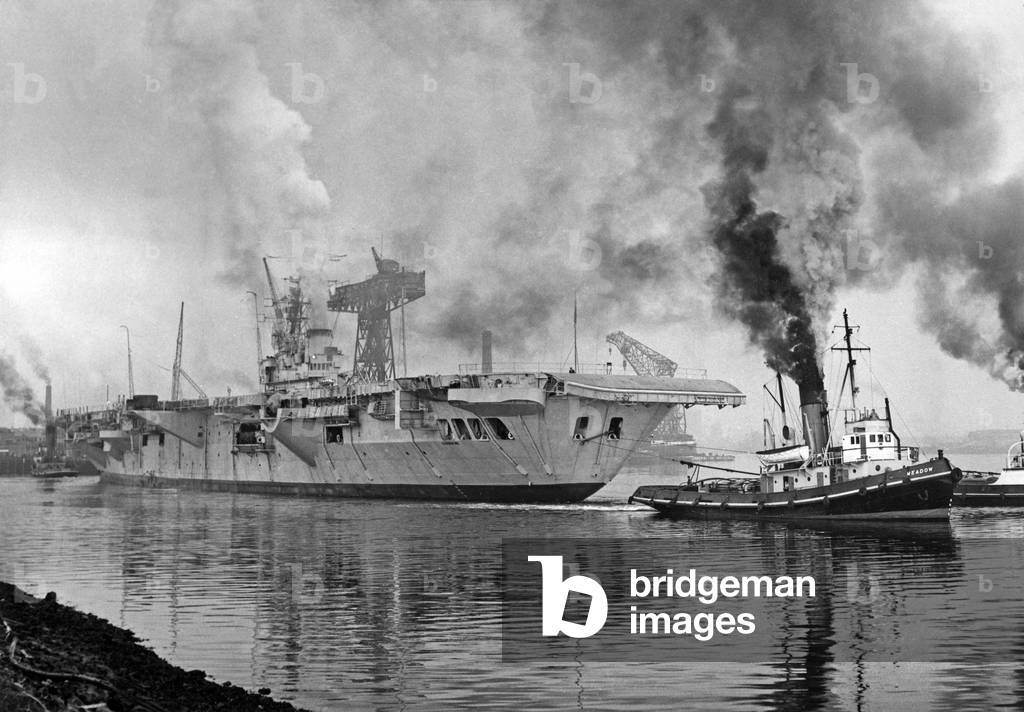 Canadian aircarftcarrier NCSM Bonaventure launched in 1945, destroyed in 1971, towed out form Belfast harbour for preliminary sea trials, October 15, 1956