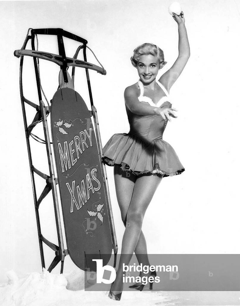 Pin-up near a sled to with a merry Christamas, 50's