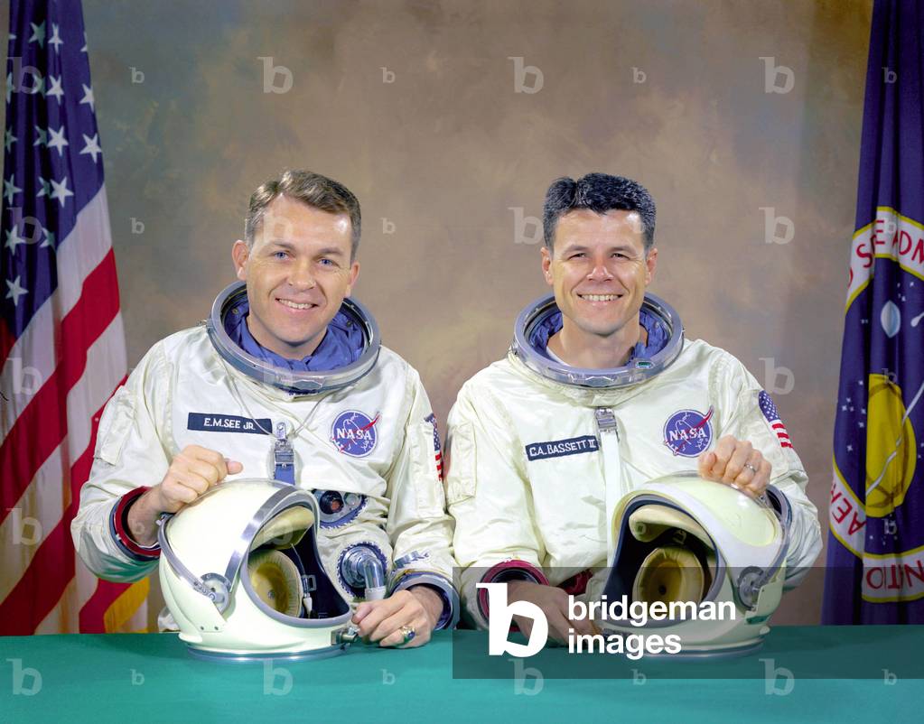 05/01/66 The original Gemini 9 prime crew, Astronauts Elliot M. See Jr. (left), command pilot, and Charles A. Bassett II, pilot, in space suits with their helmets on the table in front of them. On February 28, 1966 the prime crew for the Gemini 9 mission were killed when their twin seat T-38 trainer jet aircraft crashed into a building in which the Gemini spacecraft were being manufactured