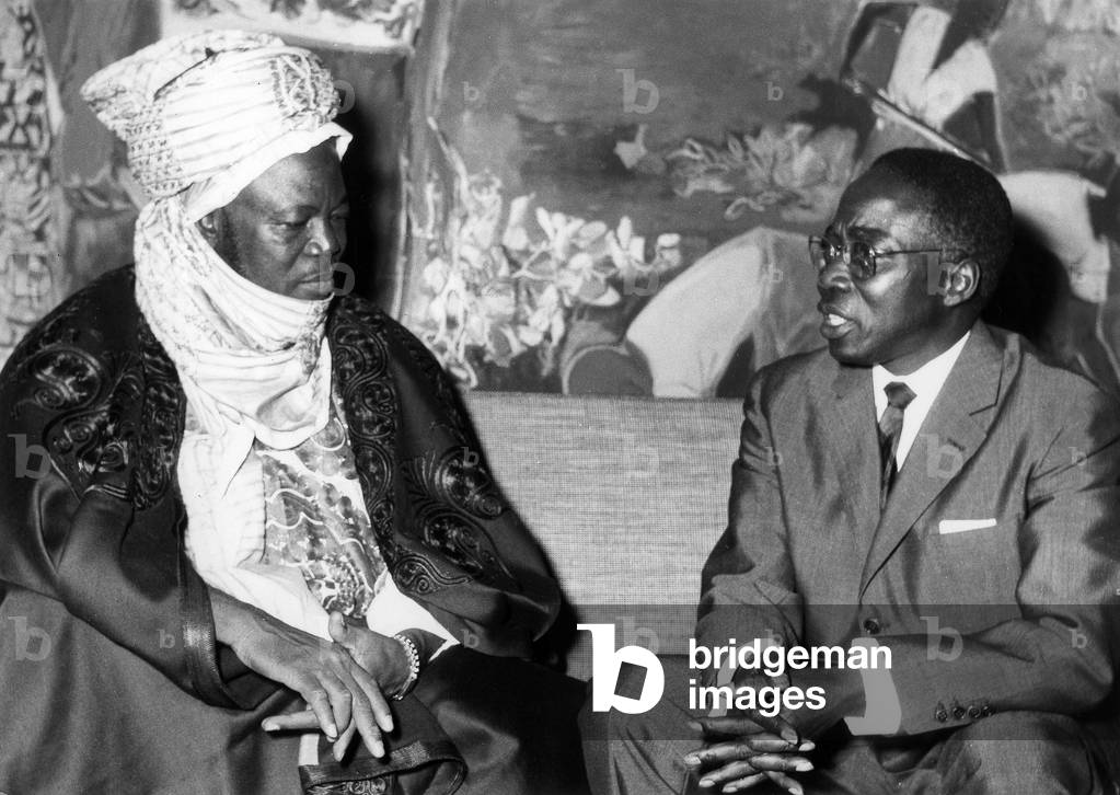 Before leaving the airport for the Palace of the Republic, President Senghor talks in the airport lounge with the Prime Minister of Northern Nigeria Sir Ahmadou Bello on 5 November 1963