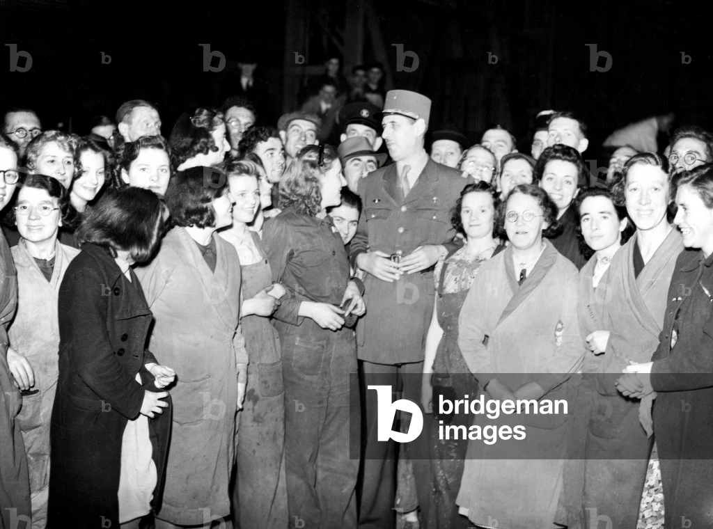General Charles de Gaulle visiting a factoy en presence of workers (women) 1944