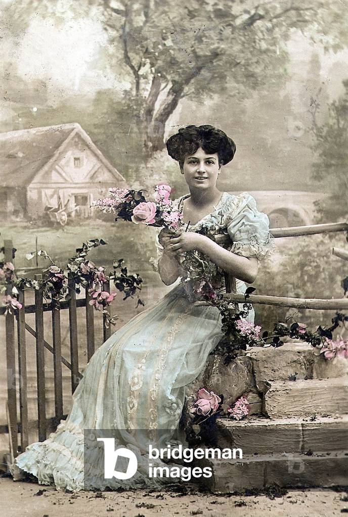 Woman with garland of flowers, postcard, c. 1900 (hand-coloured photo)
