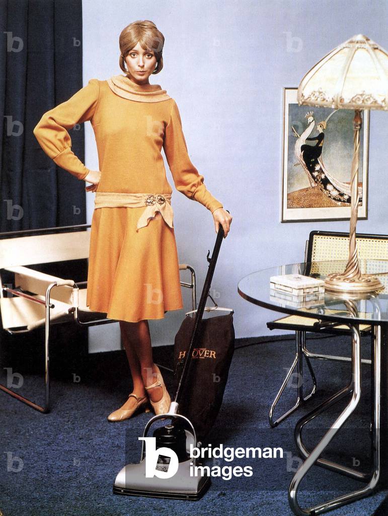 Woman doing the housework with a 1937 Hoover vacuum cleaner