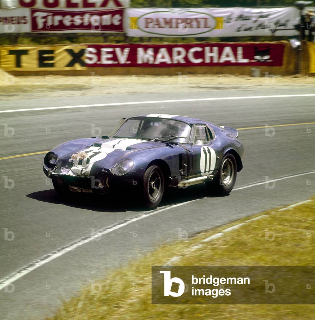 A Cobra Daytona Ford, Le Mans, France, 1965. Racing round a bend. The front of the car has taken a knock. Driven either by Jack Sears or Richard Thompson. They won the GT 4001-5000cc class