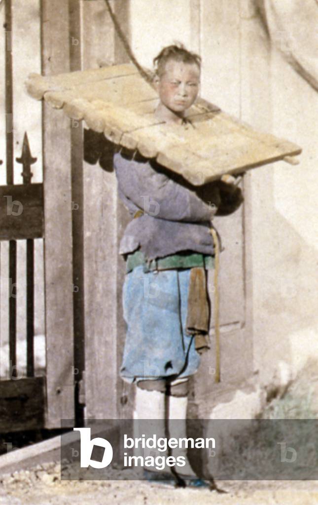 Chinese beggar being punished with his head in a canque, c 1870