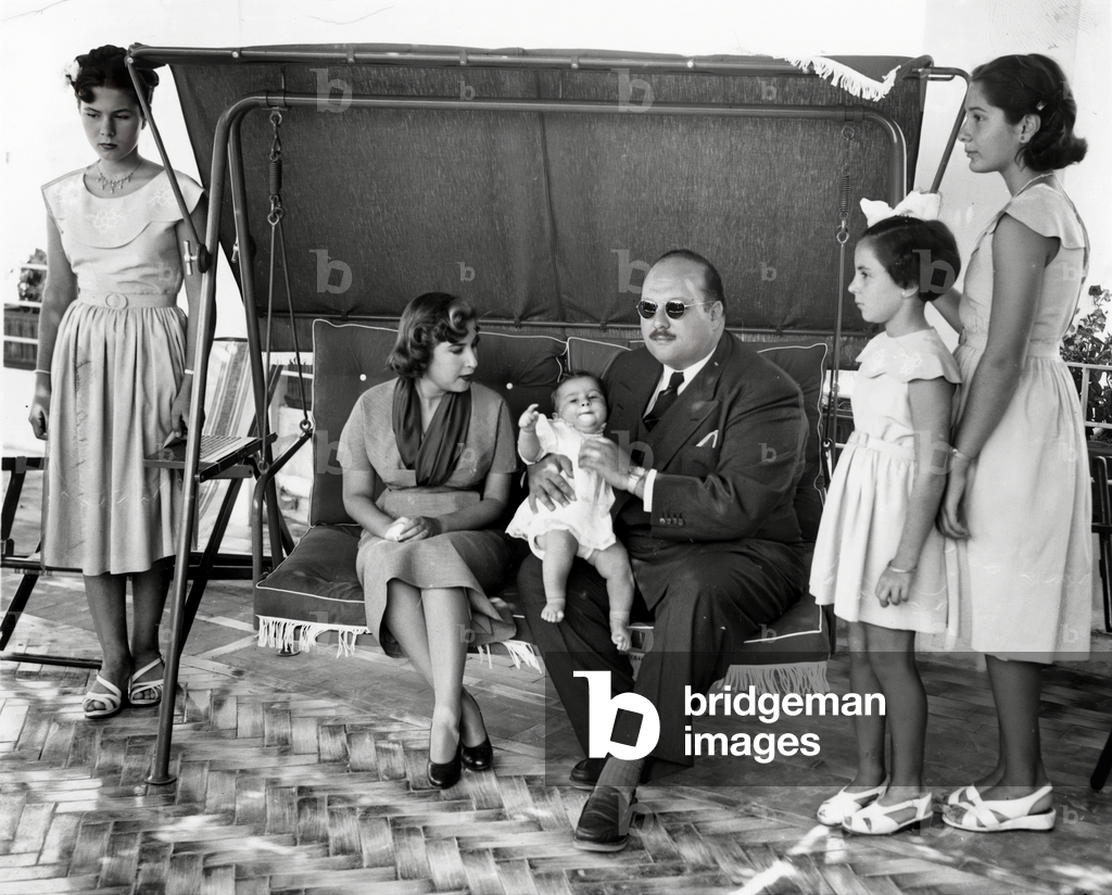 King Faruk 1st of Egypt, holding his son King  Fuad II, with his 2nd wife Queen Narriman Sadek on the Isle of Capri July-August 1952 after Farouk's deposition (with them Farouk's daughters Ferial, Fawzia and Fadia)