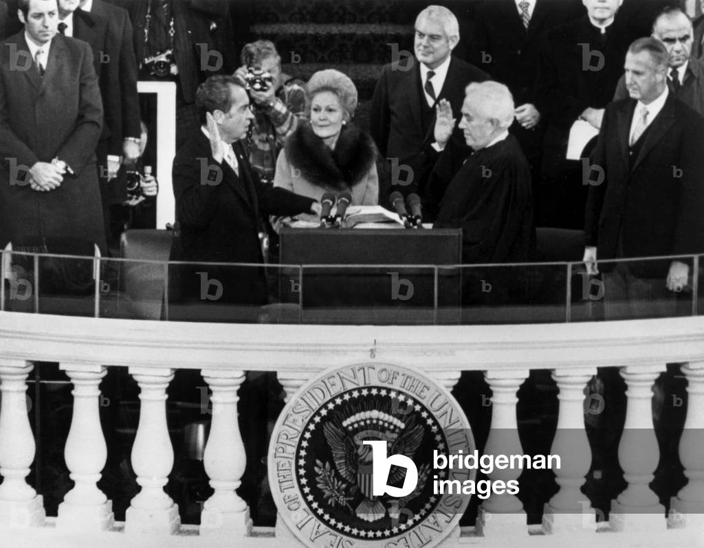Inauguration of U.S. President Richard Nixon (far left), administered by Chief Justice Warren Burger (far right), with First Lady Pat Nixon in the center, and Senator Marlow Cook (background, right), Washington D.C., January 20, 1973