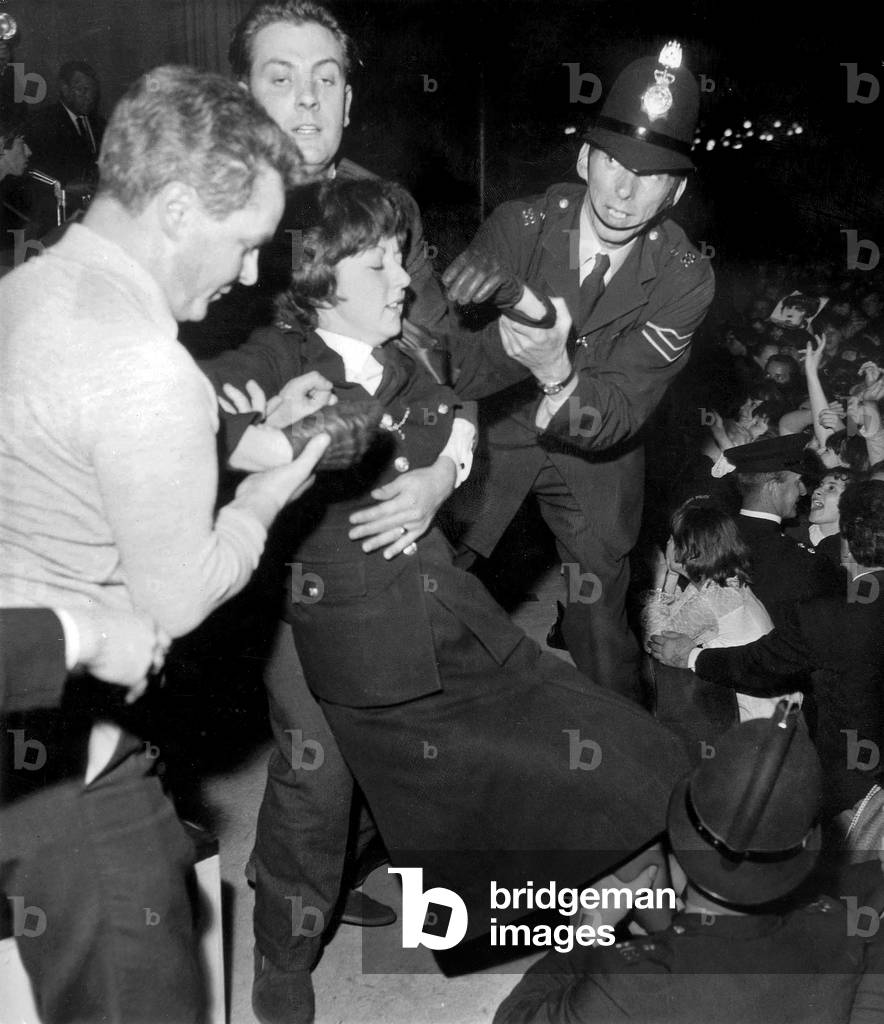 Woman taken by policemen during a concert of Rolling Stones on October 8, 1964