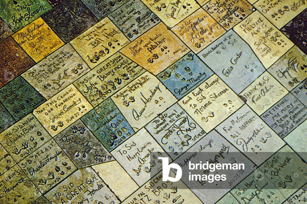 hand and foot prints and celebrity signatures on modern Hollywood floor