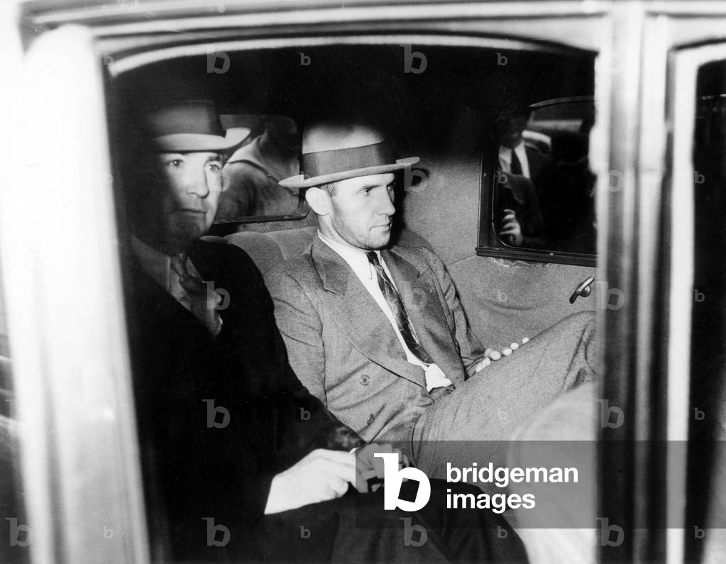 Lindbergh affair : Bruno Richard Hauptmann, accused of being the kidnapper and murderer of Ann Morrow and Charles Lindbergh's son, here in a police car as he left New York Police headquarters for arraignment in a Bronx court September 1934