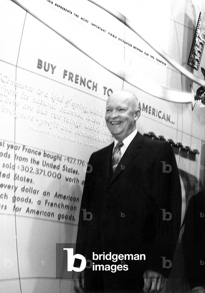 American President Dwight Ike Eisenhower during short visit in New York here at the French Exhibition of the World Fair at the New york Colliseum May 16, 1959 behind him on the wall, slogan says Buy French