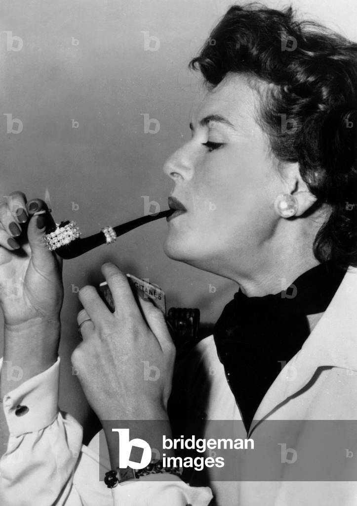 Neg: 23433PL A pipe adorned with precious stone offered by an admirer to London model Audrey White September 21, 1954