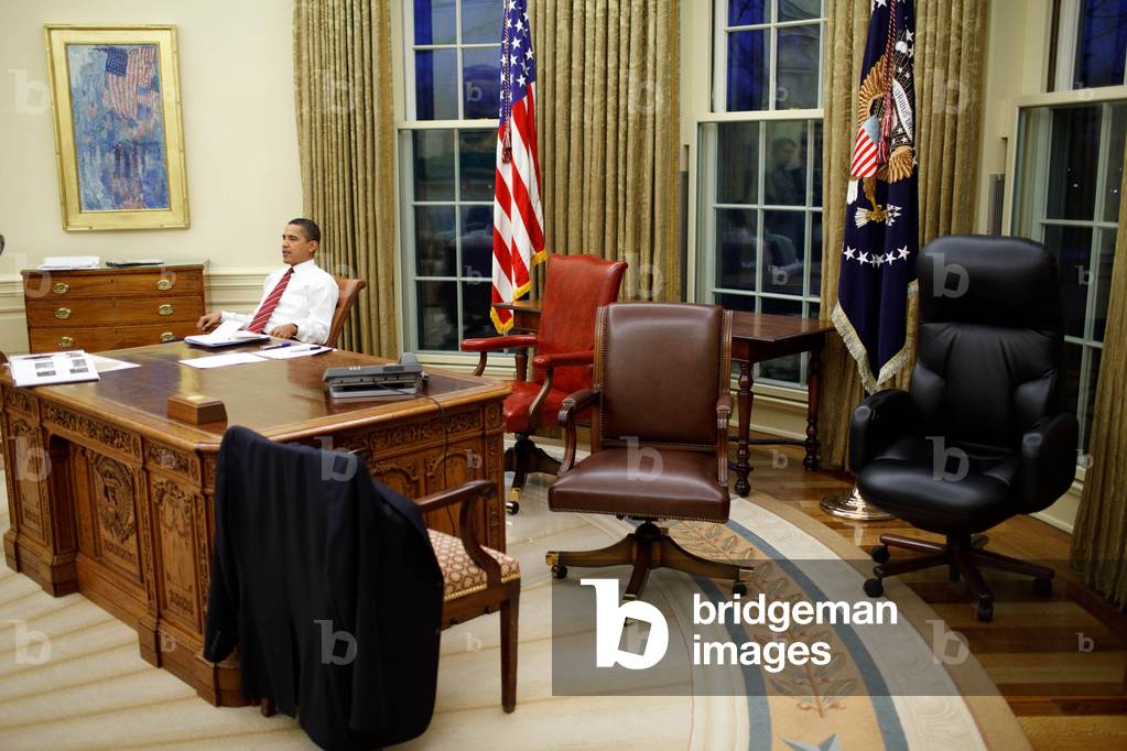 President Barack Obama tries out different desk chairs in the Oval Office January 30, 2009