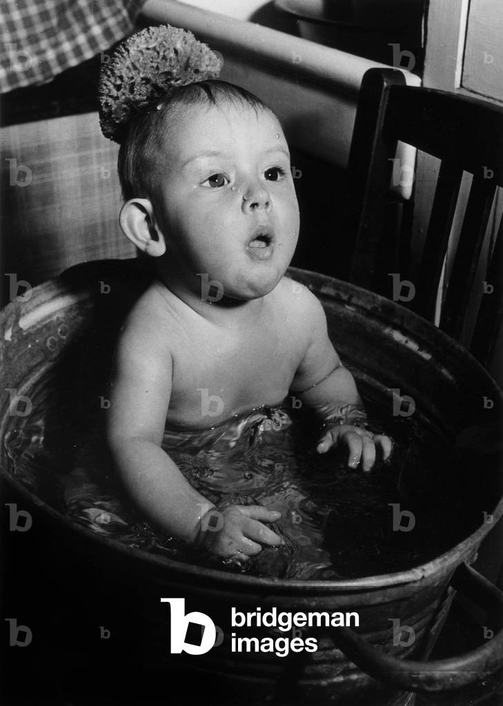 Baby in a bath (b/w photo)